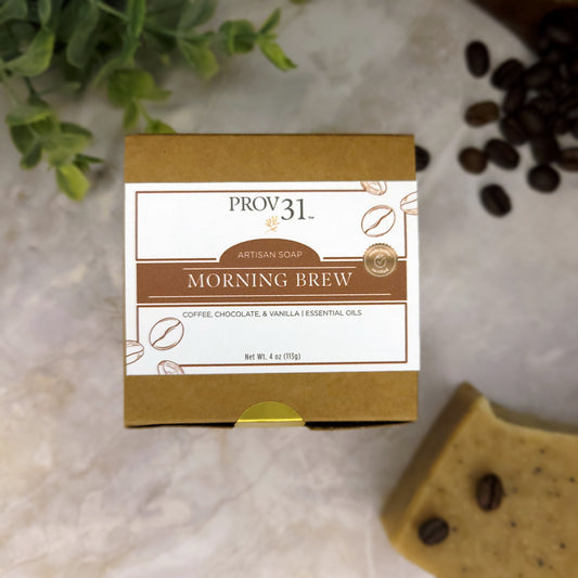 PROV 31 coffee artisan soap on marble with coffee beans and foliage in background.